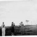 Man and two ladies having a drink from flask