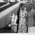 Man and woman next to statues