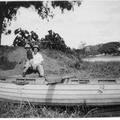 Fred Cartner and child next to a boat