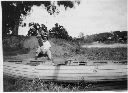 Fred Cartner and child next to a boat