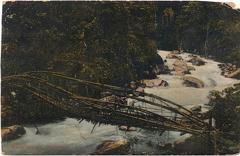 Man on wooden bridge over river