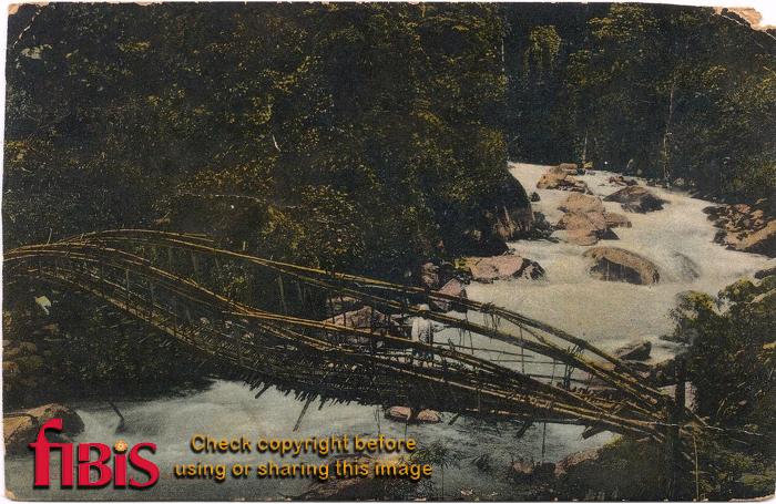 Man on wooden bridge over river